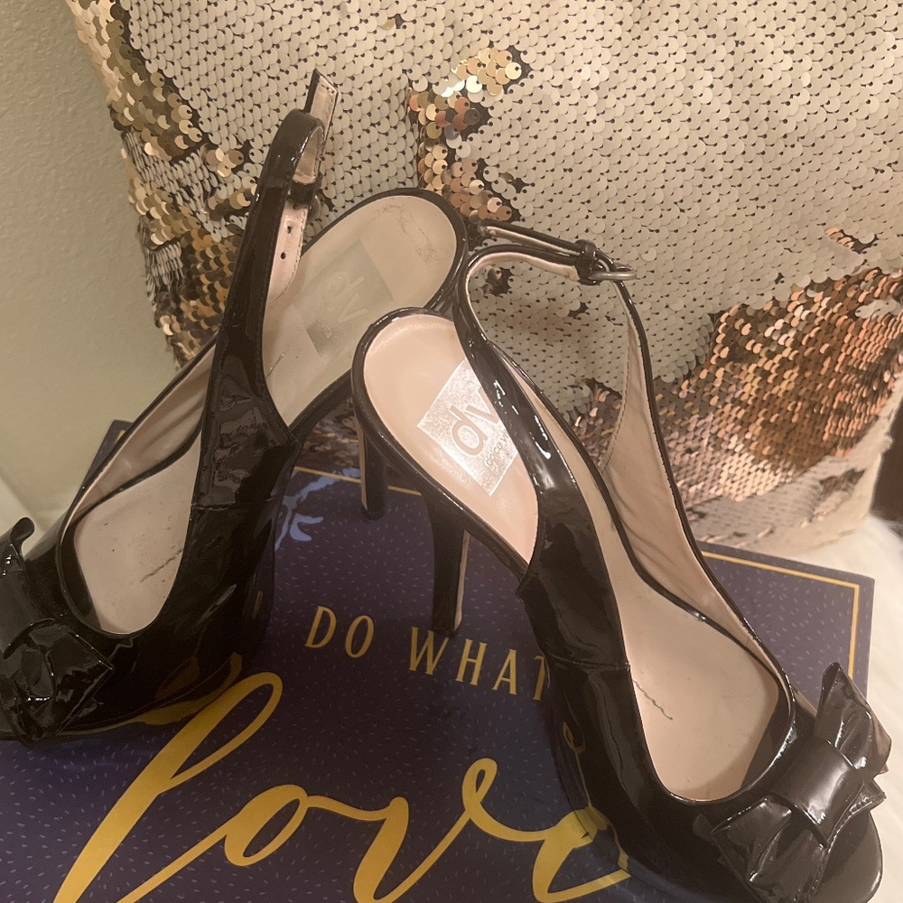 Black patent leather, open toe, sling back, stiletto heels.